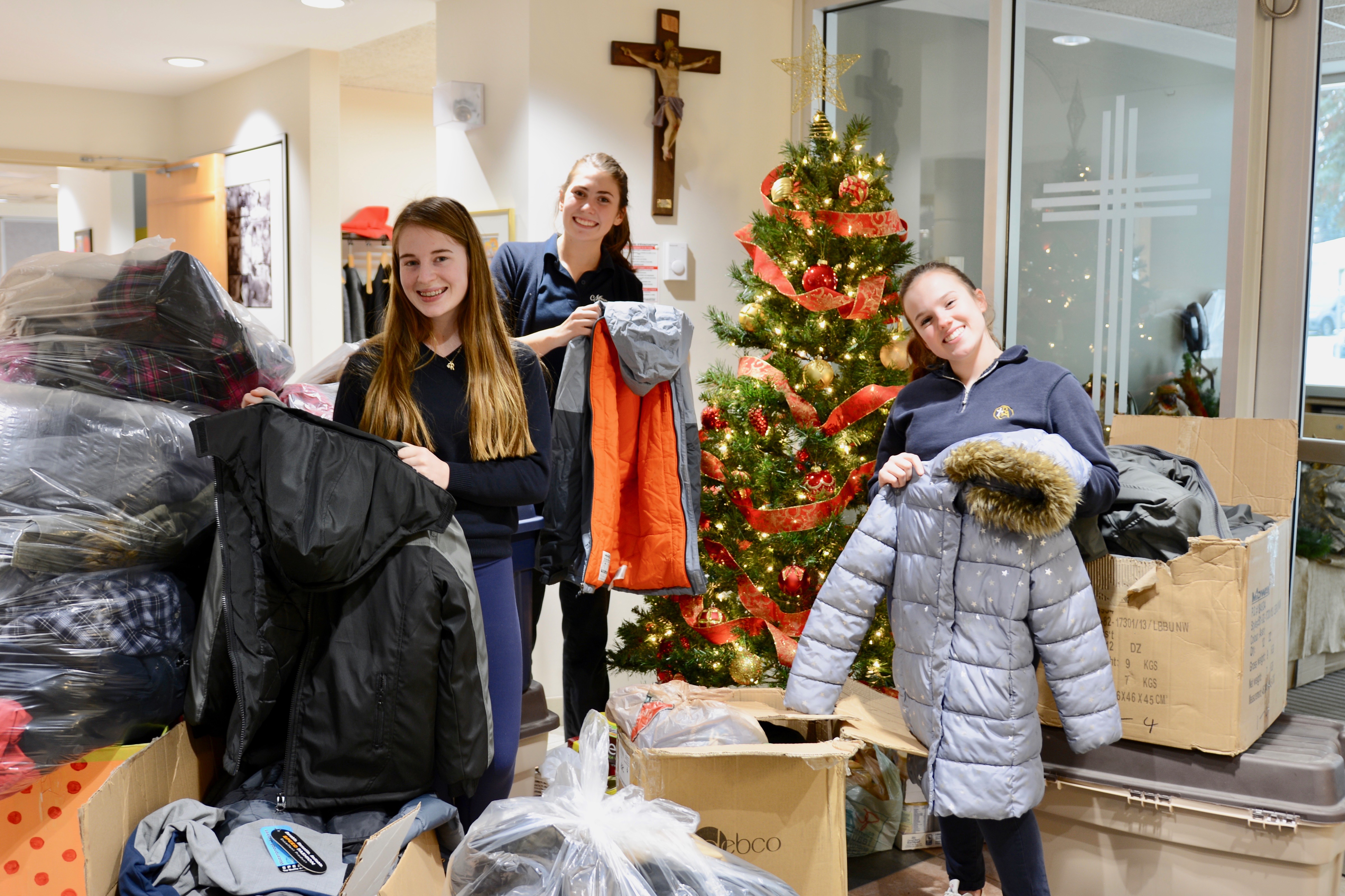Student Senate members Kira Gouchie and Megan Santi along with fellow student Kendra Brown stand proudly with coat and winter donations. The donations will help families in need this holiday season!